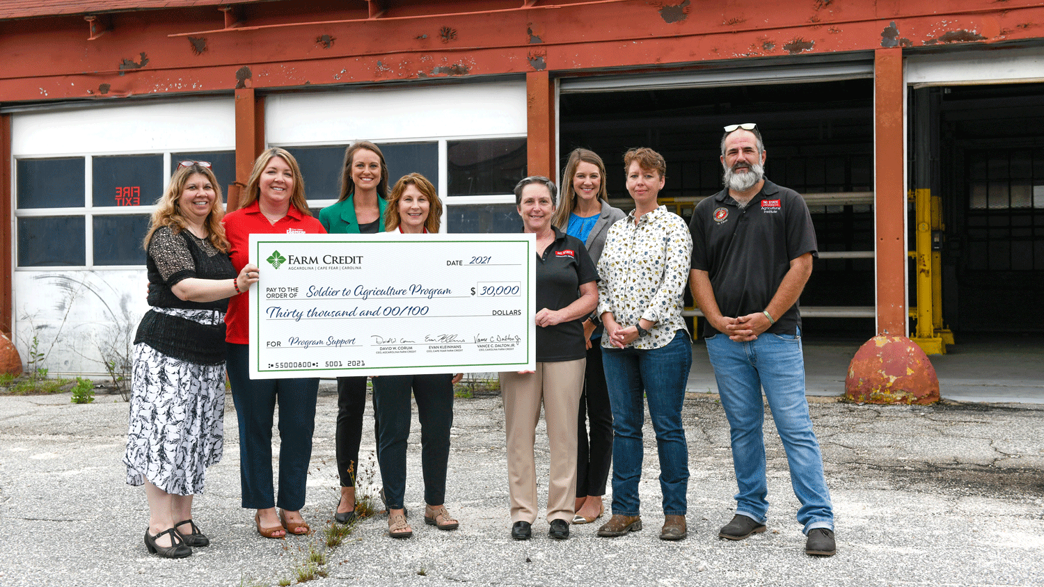 Individuals with the Farm Credit Associations of North Carolina present a $30,000 check to NC State.